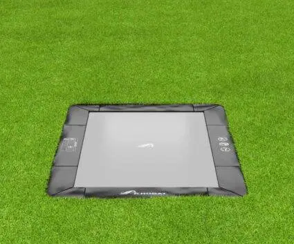 A square trampoline set on vibrant grass, perfect for jumping and enjoying outdoor activities.