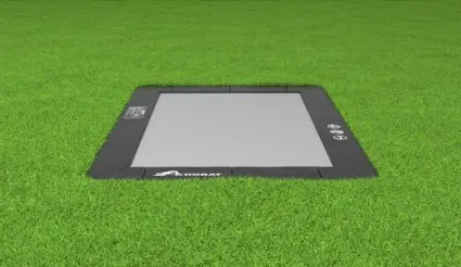 A tablet placed on lush grass, set against a backdrop of rich greenery, creating a peaceful and natural atmosphere.