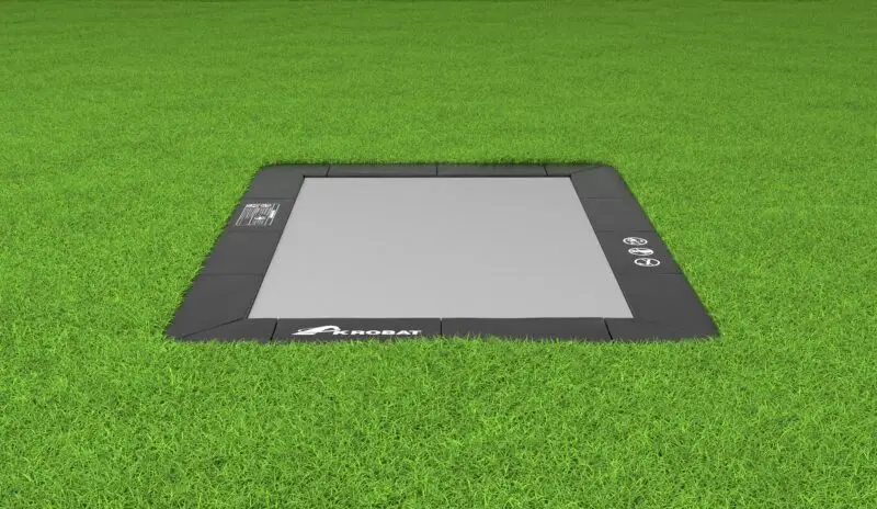 A tablet placed on lush grass, set against a backdrop of rich greenery, creating a peaceful and natural atmosphere.