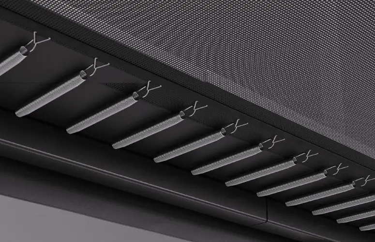 A black and white image showcasing a textured wall featuring a prominent metal grill design.