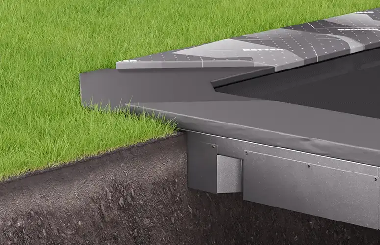 A sturdy metal trampoline placed on a lush green grass area, perfect for recreational activities.