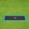 A black and green square trampoline set on a grassy area, inviting for outdoor fun and exercise.