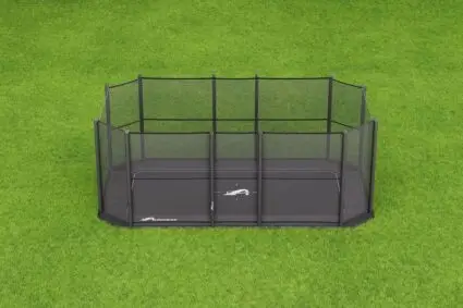 A compact black cage placed on lush green grass, highlighting a tranquil and natural environment.