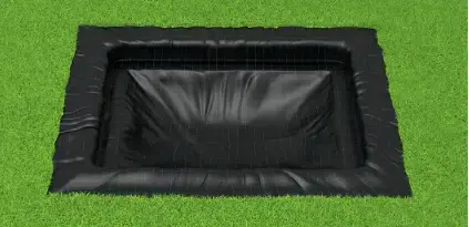 A black square positioned on grassy ground, adorned with a green cover, blending elements of color and texture.