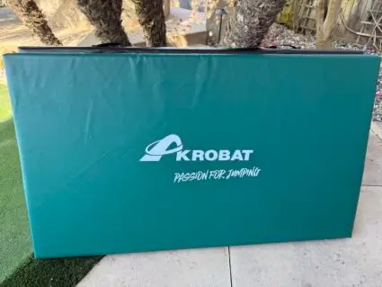 AkrobatUSA Landing Mat 11 A repetitive pattern of the word kobat displayed multiple times in a visually striking arrangement.