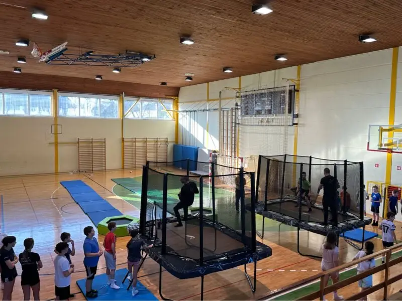 kids in school jumping on trampoline